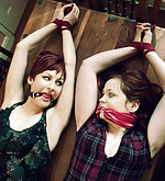 Two girls roped together and gagged